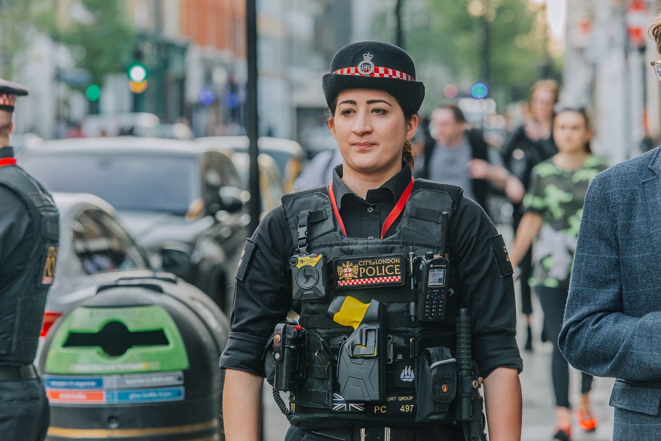 a patrolling female officer wearing a Taser on her chest.